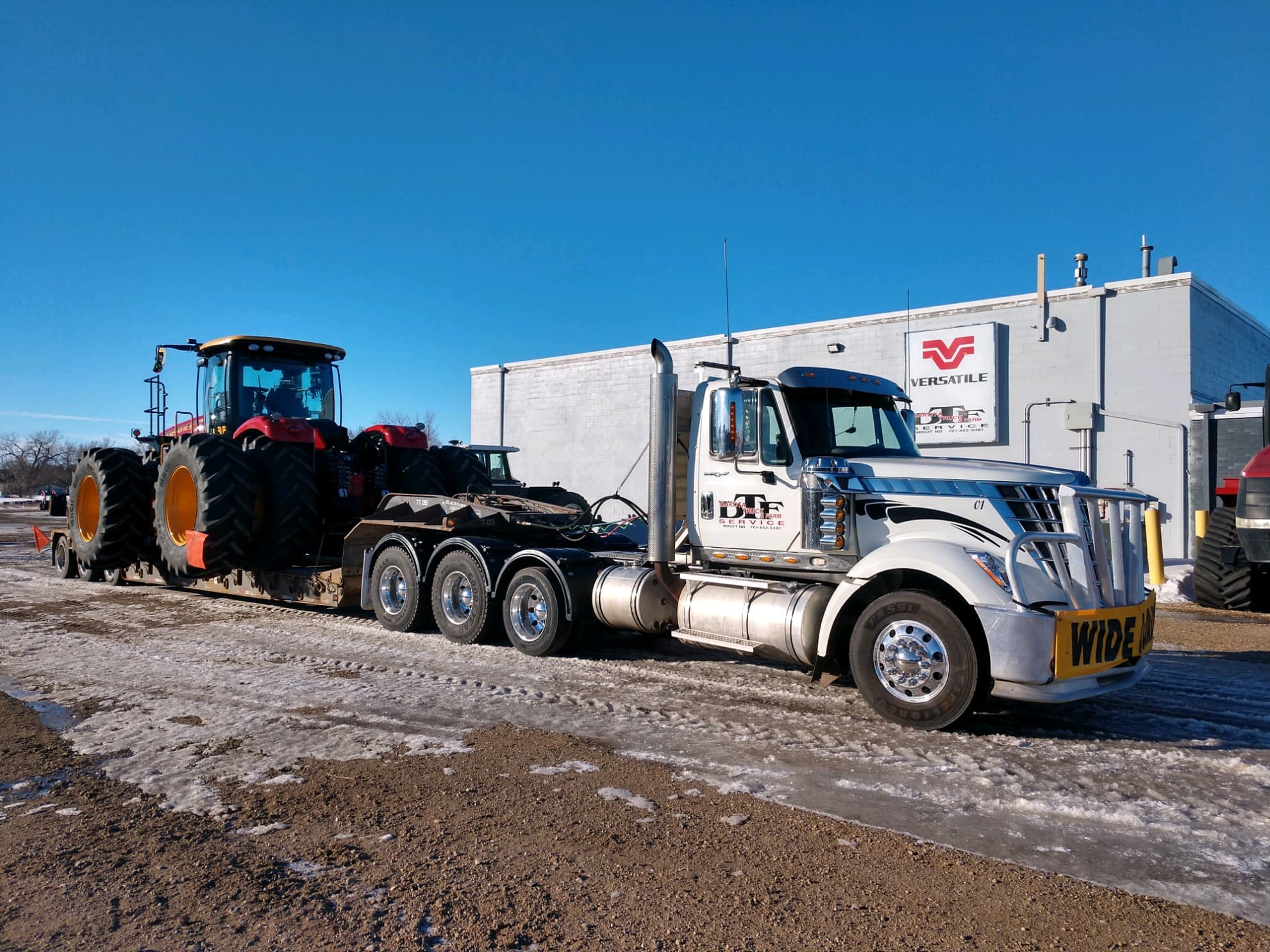 Clints delivery truck with tractor on the trailer