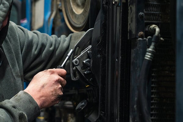 Mechanic working on implement